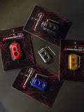 Three small electronic devices on cards with 'kansomotor' branding on a dark surface.